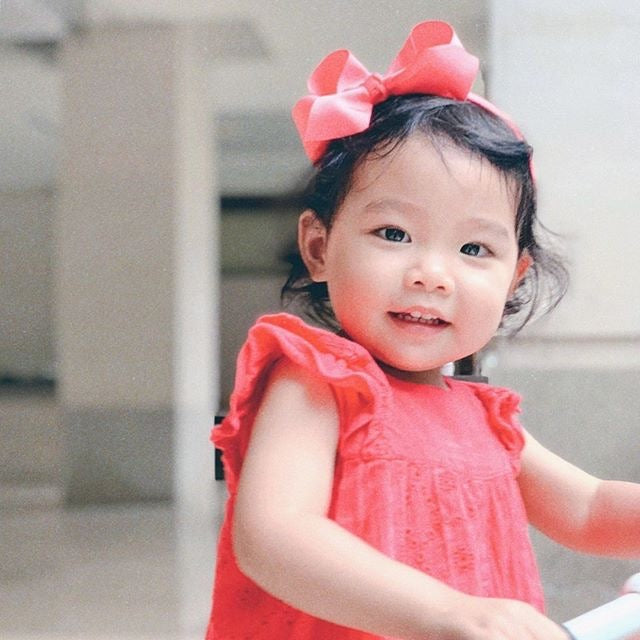 Adorable Alice Bow Headband in Coral. Perfect to complete an outfit or to dress up